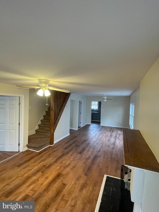 unfurnished living room featuring hardwood / wood-style floors and ceiling fan