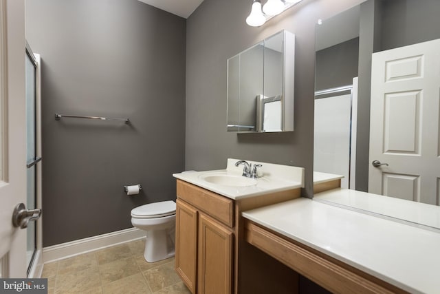 bathroom with an enclosed shower, vanity, and toilet