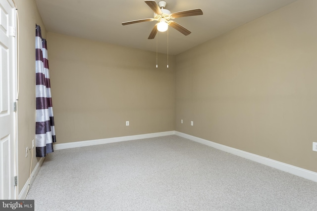 unfurnished room featuring ceiling fan and light carpet