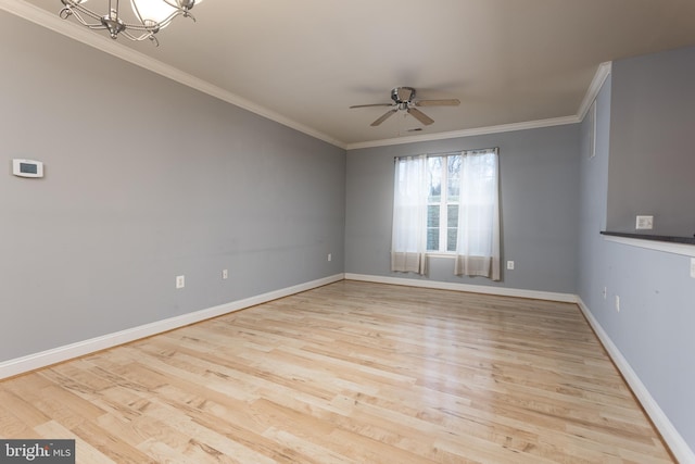 spare room featuring ceiling fan with notable chandelier, light hardwood / wood-style flooring, and ornamental molding