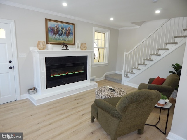 living room featuring light wood-type flooring and ornamental molding