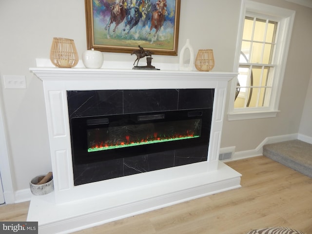 interior details with hardwood / wood-style floors and a fireplace