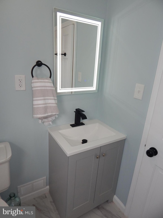 bathroom featuring vanity and toilet