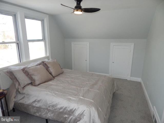 carpeted bedroom featuring ceiling fan and vaulted ceiling