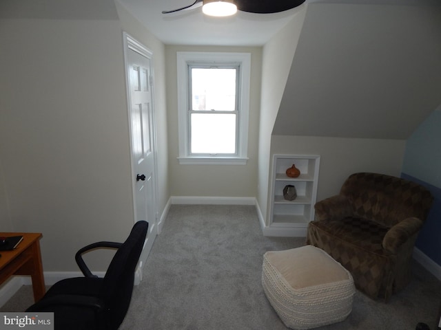 carpeted home office featuring ceiling fan