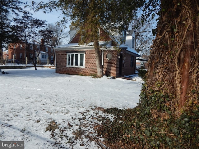 view of snow covered back of property