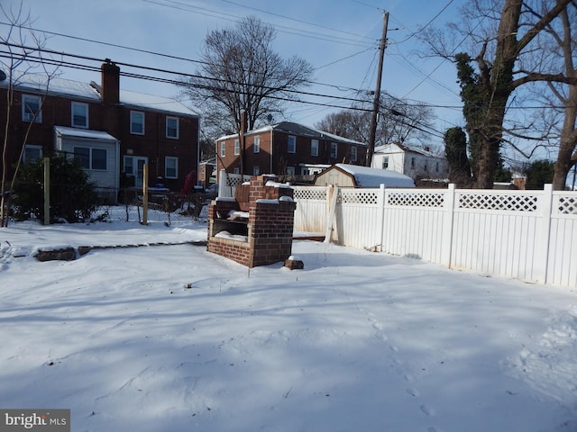 view of yard layered in snow