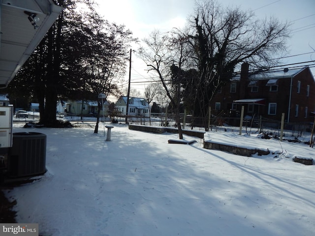 yard covered in snow with central air condition unit