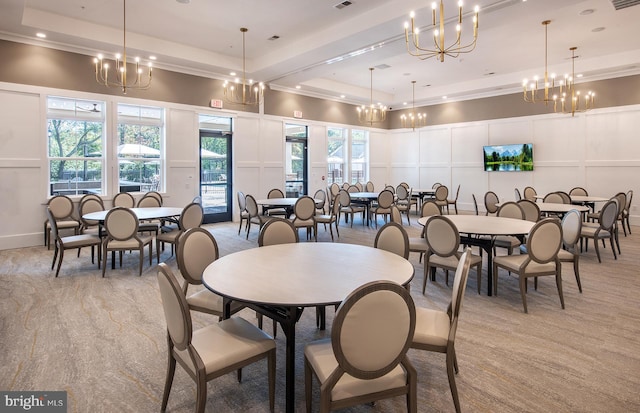 dining area featuring a tray ceiling, light colored carpet, and a healthy amount of sunlight