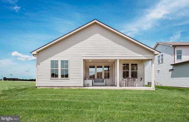 rear view of property with a lawn and a patio