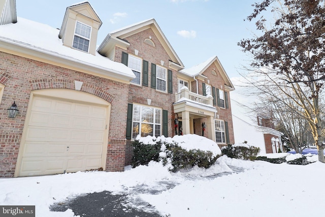 view of front of home with a garage and a balcony