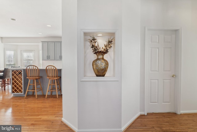 corridor with light hardwood / wood-style flooring