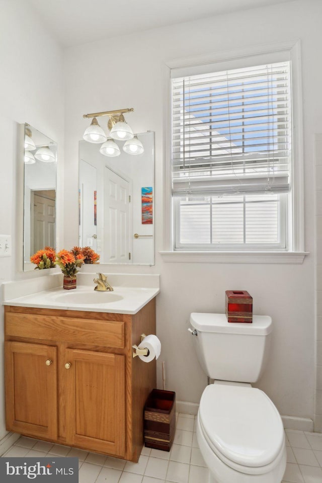 bathroom featuring tile patterned floors, vanity, and toilet