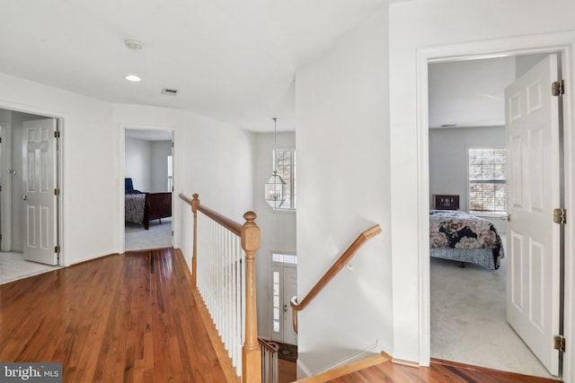 corridor with hardwood / wood-style floors