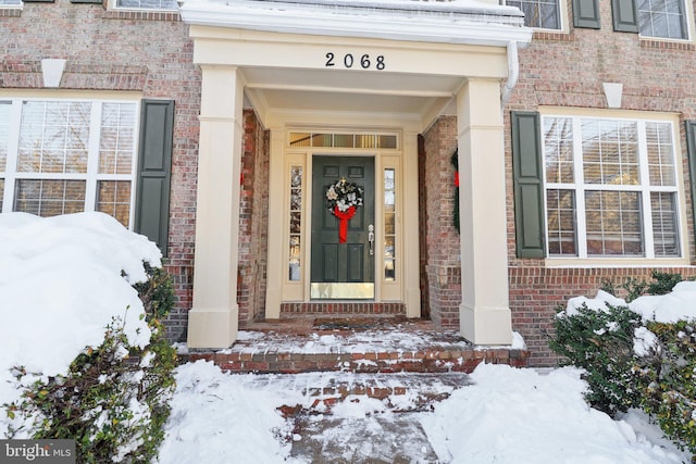 view of snow covered property entrance