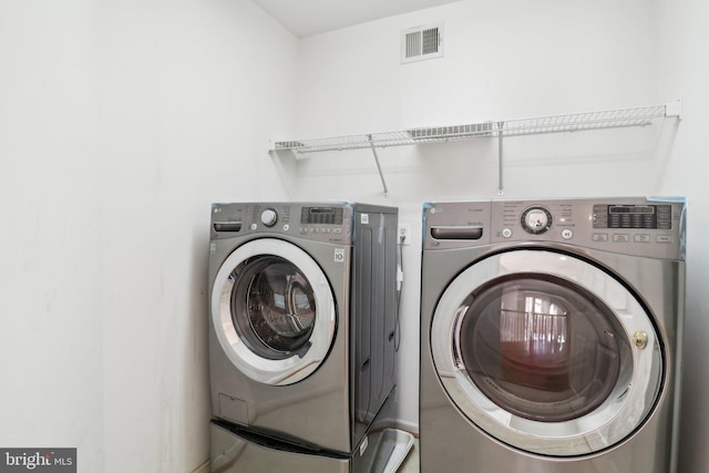 clothes washing area featuring washing machine and clothes dryer