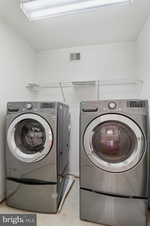 washroom featuring independent washer and dryer