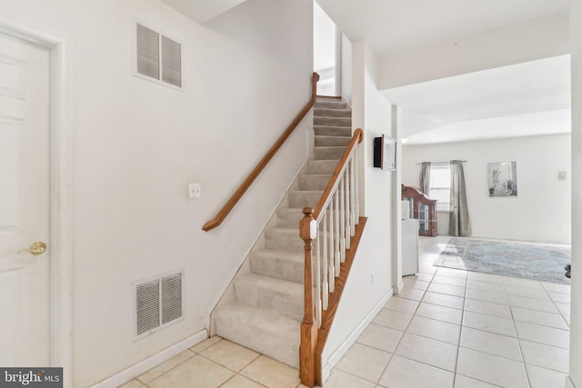 stairs featuring tile patterned flooring