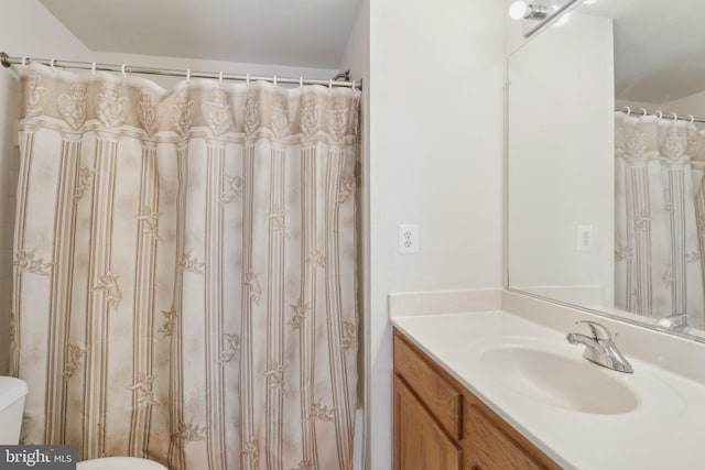 bathroom with vanity, toilet, and walk in shower