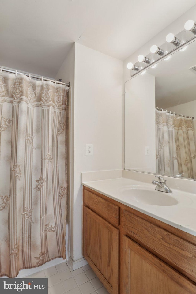 bathroom featuring a shower with curtain, vanity, and tile patterned floors