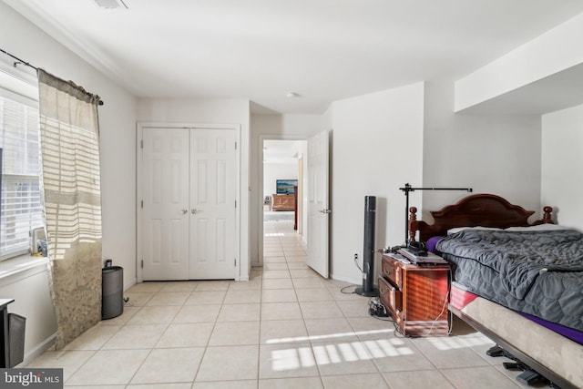 tiled bedroom with a closet