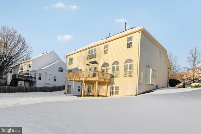 rear view of house featuring a wooden deck