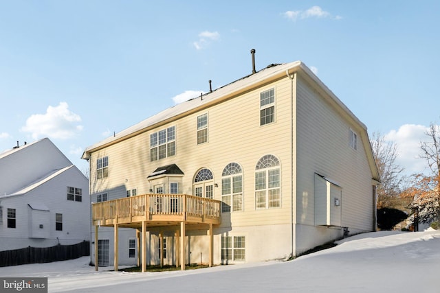 rear view of house featuring a wooden deck