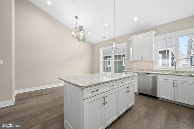 kitchen with dark hardwood / wood-style flooring, a kitchen island, decorative light fixtures, dishwasher, and white cabinetry