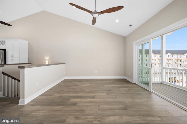 empty room featuring dark hardwood / wood-style floors, high vaulted ceiling, and ceiling fan