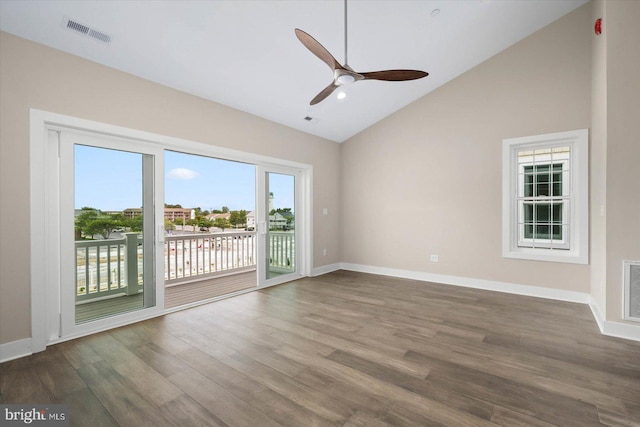 spare room with ceiling fan, wood-type flooring, and vaulted ceiling