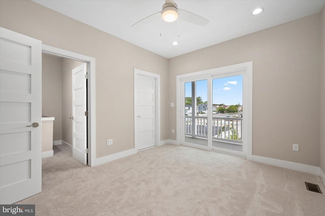 unfurnished bedroom with access to outside, ceiling fan, and light colored carpet