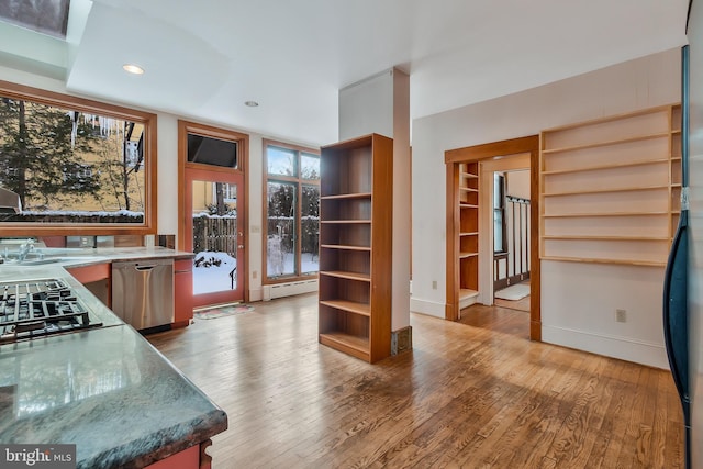 kitchen featuring gas cooktop, a baseboard radiator, dishwasher, and hardwood / wood-style floors