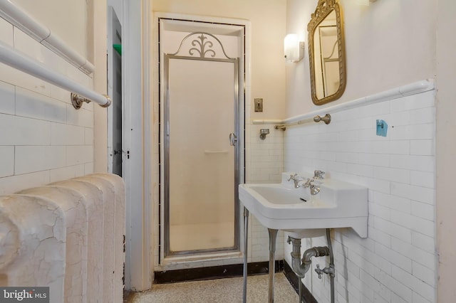 bathroom featuring an enclosed shower and sink