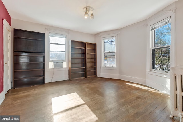 unfurnished living room with hardwood / wood-style flooring and a healthy amount of sunlight