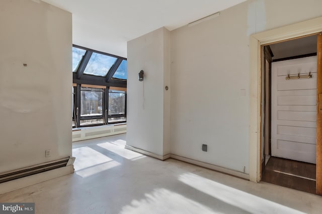 unfurnished room with a skylight