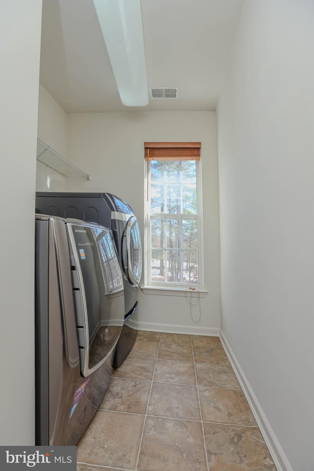 clothes washing area featuring independent washer and dryer