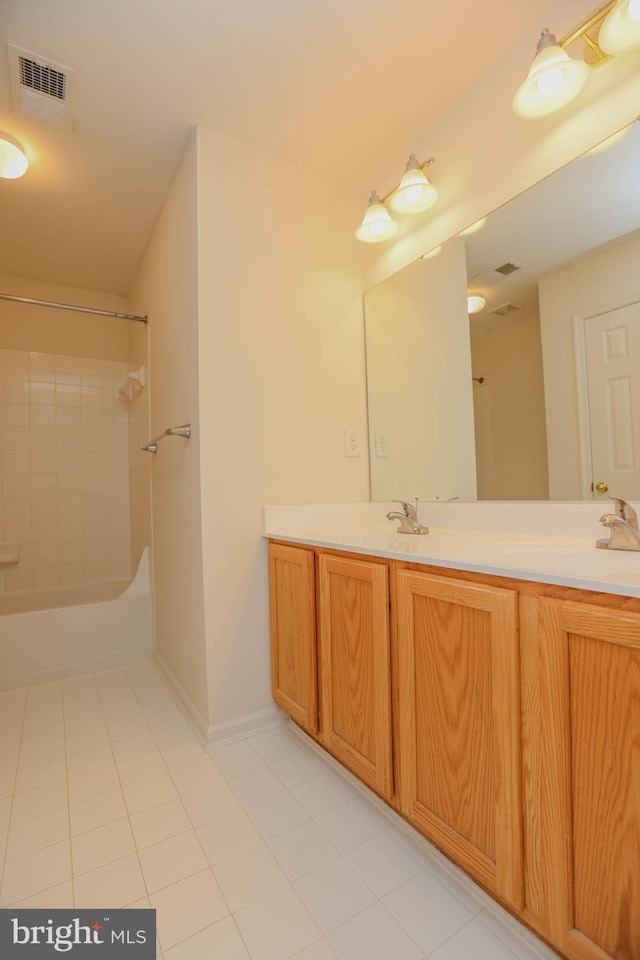 bathroom featuring vanity, tile patterned floors, and tiled shower / bath