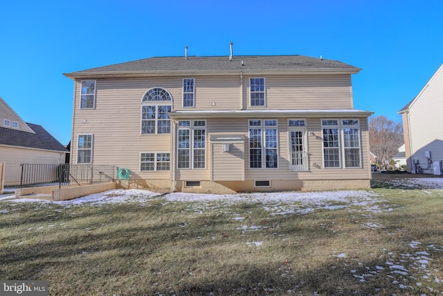 rear view of property featuring a yard