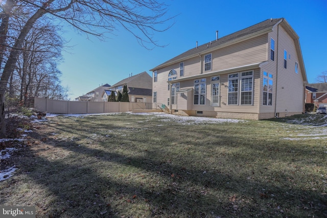 rear view of house with a lawn