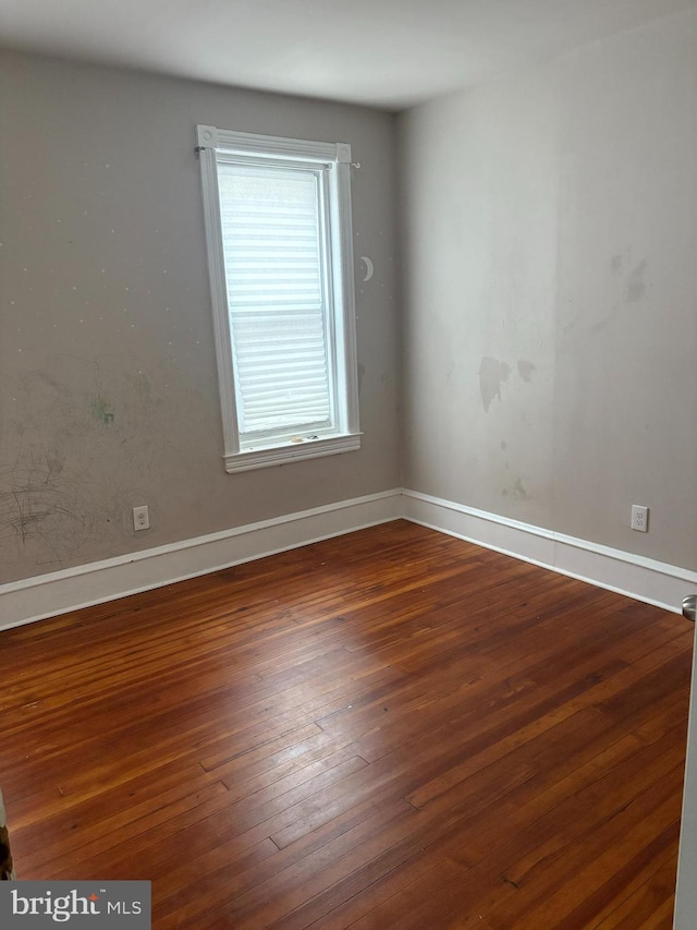 unfurnished room featuring dark wood-type flooring