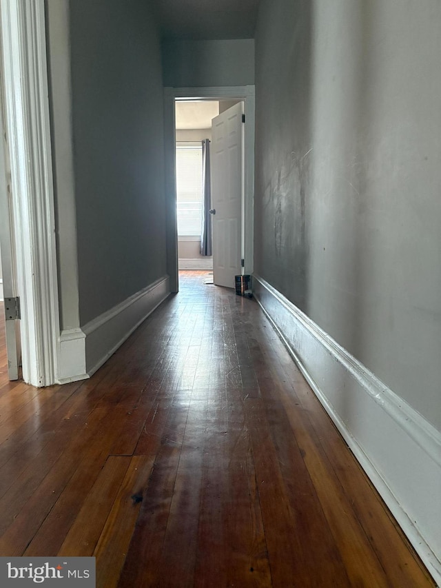 hallway with dark wood-type flooring