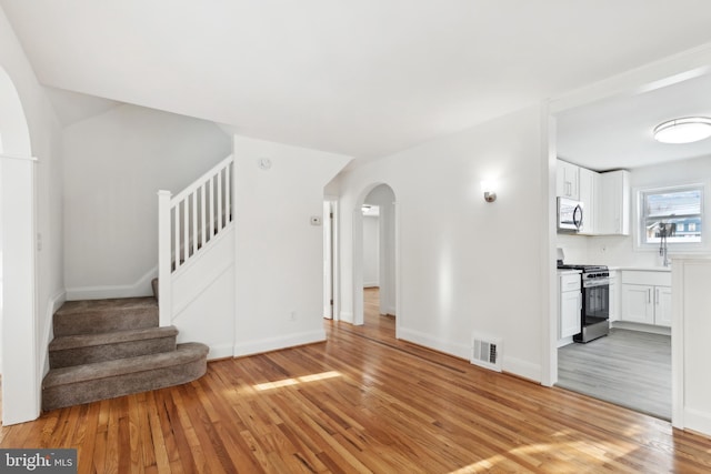 unfurnished living room with light hardwood / wood-style floors