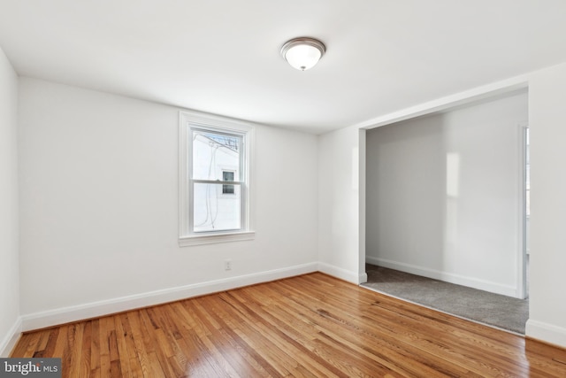 unfurnished bedroom with hardwood / wood-style flooring and a closet