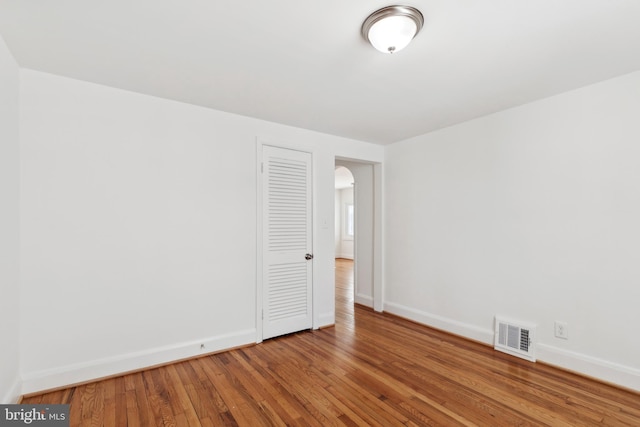 empty room with hardwood / wood-style floors