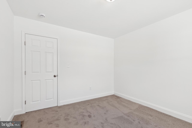 empty room featuring light colored carpet