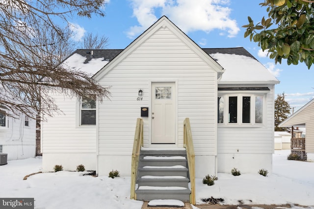 bungalow-style house featuring central AC unit