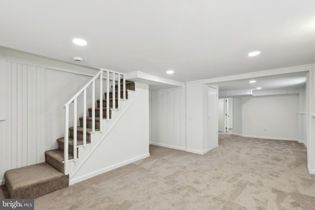 basement featuring light carpet