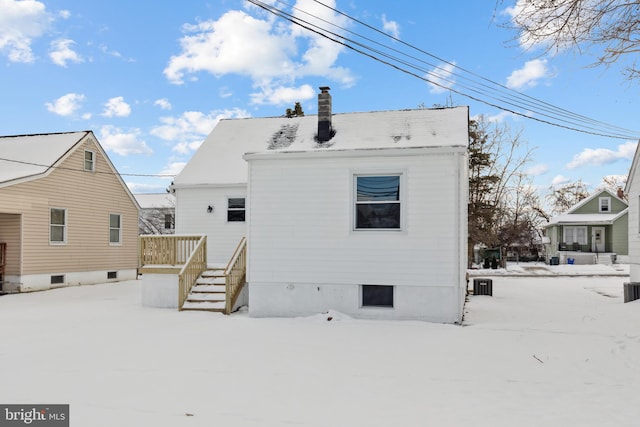 view of snow covered rear of property