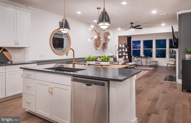 kitchen with sink, stainless steel dishwasher, ceiling fan, decorative light fixtures, and white cabinetry