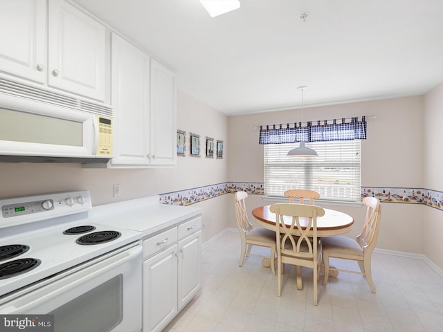 kitchen featuring pendant lighting, white cabinetry, and white appliances